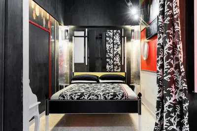 a bedroom with a bed in a black room at Appartamenti MarcoAurelio49 in Rome
