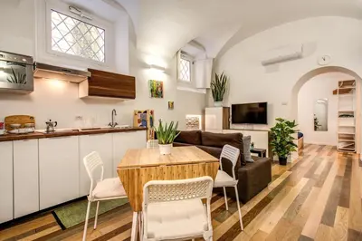 a kitchen and living room with a table and chairs at FRESH HOUSE NAVONA in Rome