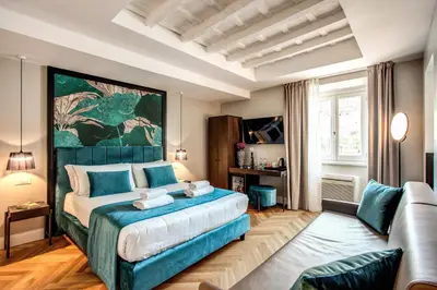 a bedroom with a large bed and a couch at Hotel 55 Fifty-Five - Maison d'Art Collection in Rome