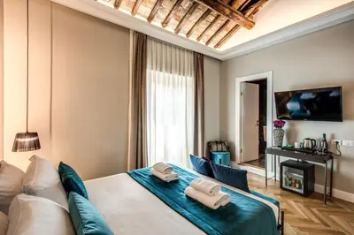 a bedroom with a bed with two towels on it at Hotel 55 Fifty-Five - Maison d'Art Collection in Rome