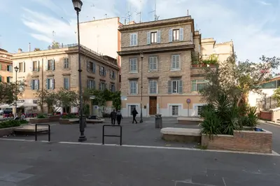 a building in a city with people walking in front of it at Take You Rome - Vatican Apartment in Rome