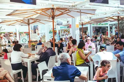 a group of people sitting at tables in a restaurant at Gli Alberi a Testaccio in Rome