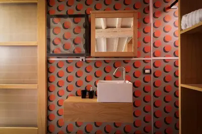 a bathroom with a sink and a mirror on a wall at Flat PIAZZA DEL POPOLO in Rome