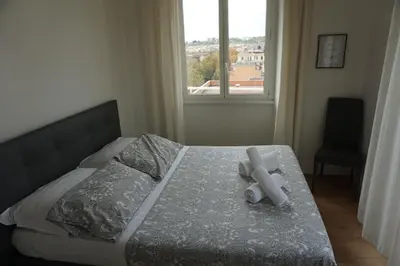 a bedroom with a bed with two candles on it at Panoramic View of St. Peter in Rome