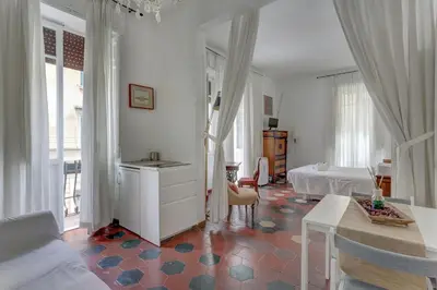 a living room with a table and a bed at Charming Colosseum in Rome