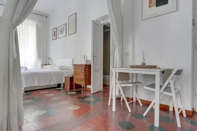 a room with a table and a bed and a desk at Charming Colosseum in Rome