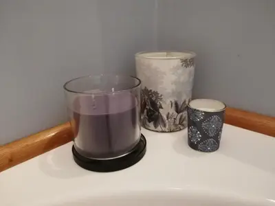 a candle and a glass sitting on a shelf at LikeYourHome, 80 sq m luxury apartment with Jacuzzi, in Trastevere district in Rome