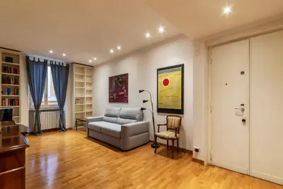 a living room with a couch and a chair at Apartment with terrace near Piazza Navona - FromHometoRome in Rome