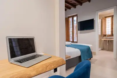 a laptop computer sitting on a desk in a bedroom at Campo de' Fiori 34 in Rome