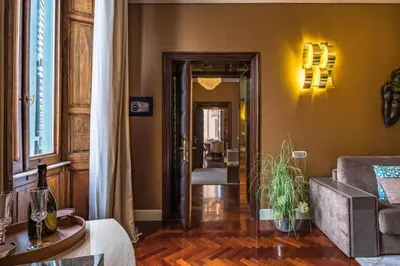 a living room with yellow walls and a room at The Inn at the Spanish Steps Luxury Collection - The Club Condotti 91 in Rome
