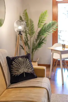 a couch with a pillow on it in a living room at Kitty Apartment - Close to the Vatican in Rome