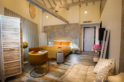 a bedroom with a bed and a tv and a couch at Rosso Cortese in Rome