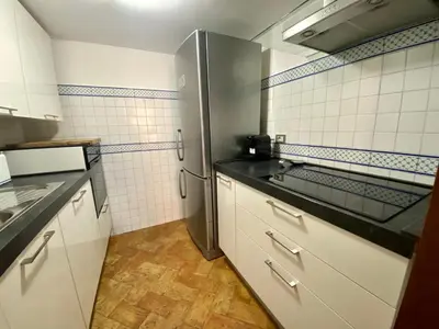 a kitchen with a stainless steel refrigerator and white cabinets at By the charming Piazza Navona - FromHometoRome in Rome
