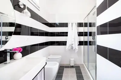 a black and white bathroom with a toilet and a shower at Casa di Artemisia in Rome