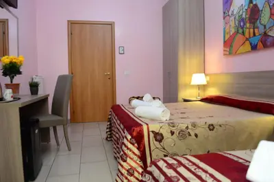 a hotel room with a bed and a desk and a desk at Roma Castle Termini in Rome