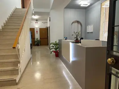 an office lobby with stairs and a reception desk at Villa Angeli in Rome