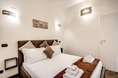 a bedroom with a bed with towels on it at Laura luxury apartment in the center Rome in Rome