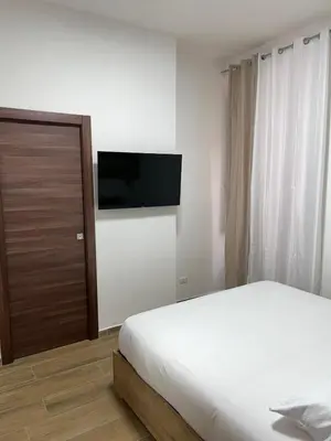 a bedroom with a bed and a flat screen tv at Laura luxury apartment in the center Rome in Rome