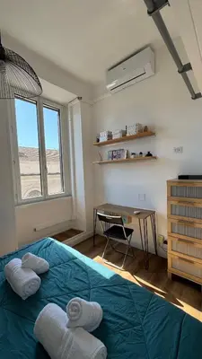 a bedroom with a blue bed with towels on it at The Rica House in Rome