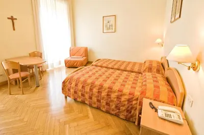 a hotel room with a bed and a table at Gästehaus Deutscher Orden in Rome