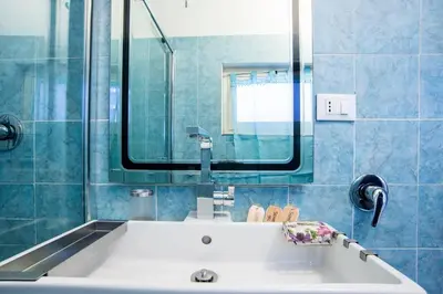 a bedroom with blue walls and a large bed at Colosseum/Panisperna Nina apartament with terrace in Rome