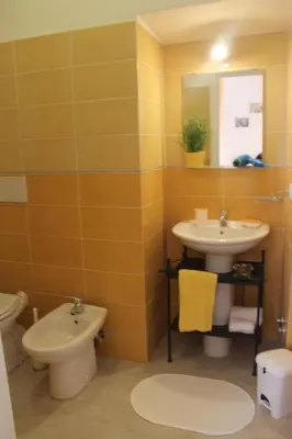 a bathroom with a sink and a toilet and a mirror at Home 103 in Rome