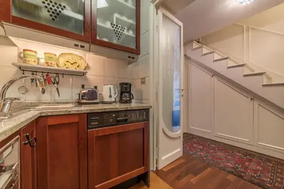 a kitchen with a sink and a staircase at Quiet and classic on two floors, by Trevi Fountain - FromHometoRome in Rome