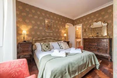 a bedroom with a bed with two towels on it at Quiet and classic on two floors, by Trevi Fountain - FromHometoRome in Rome