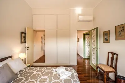 a bedroom with a bed and a chair in a room at Roof top dream piazza del popolo in Rome