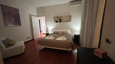 a small bedroom with a bed and a couch at FG St Peter's Suites in Rome