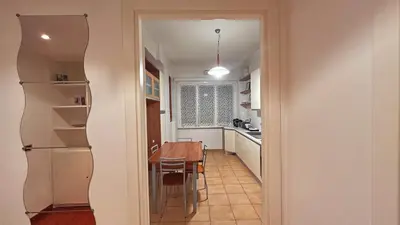 a kitchen with a table and a dining room at FG St Peter's Suites in Rome