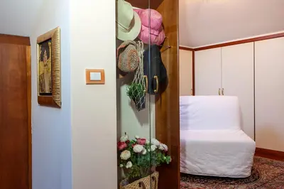 a room with a bed and a door with flowers at I Villini del Pigneto in Rome