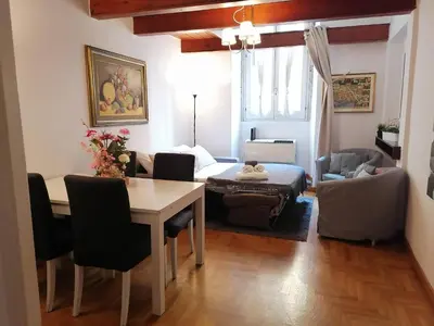 a living room with a table and a dining room at Coronari 45 apartment in Rome