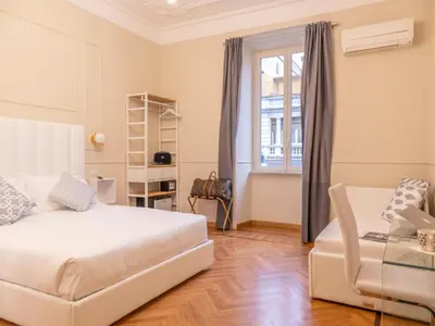 a bedroom with a bed and a chair and a window at Vatican Palace Suites by Premium Suites Collection in Rome
