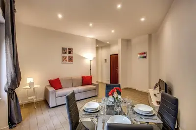 a living room with a table and a couch at M&L Apartment - Ardesia Terrace in Rome