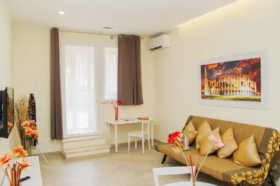 a living room with a couch and a table at DOMUS DIVI - appartamento nel cuore di Roma in Rome