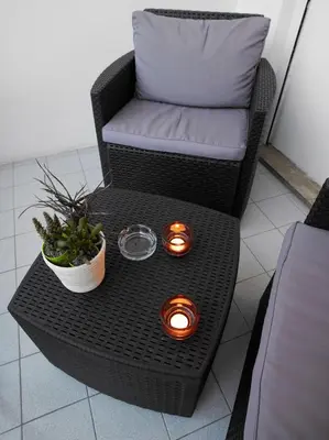 a wicker chair and a table with lights on it at Jazz Style in Rome