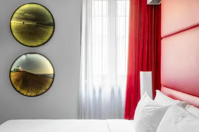 a bedroom with two mirrors on the wall at BDB Rooms Margutta in Rome