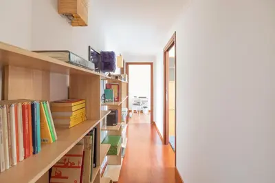 a room with bookshelves and a hallway with a table at Like At Home Piramide in Rome