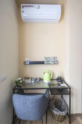 a desk with a blue chair in a room at Bed & Breakfast Vacanze Romane in Rome