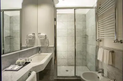 a bathroom with a shower and a sink and a toilet at Nazionale 51 L Rooms in Rome