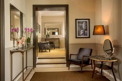 a hallway leading to a living room with a mirror at Nazionale 51 L Rooms in Rome
