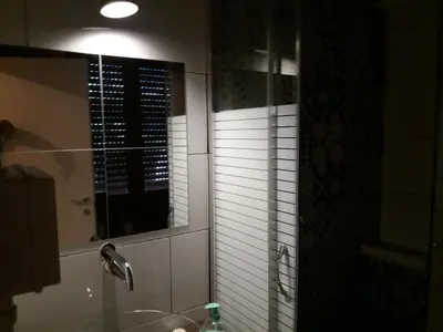 a bathroom with a shower and a sink and a mirror at Roma Trastevere Station in Rome