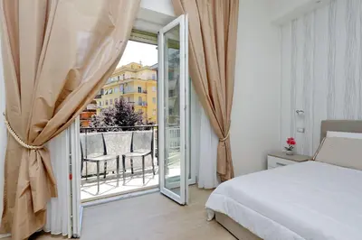 a bedroom with a bed and a sliding glass door at My Little Holiday in Rome