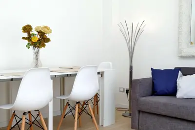 a living room with a table and chairs and a couch at My Little Holiday in Rome
