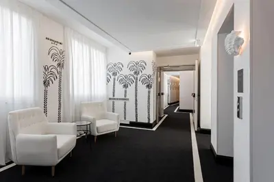 a waiting room with two chairs and a table at Room Mate Collection Filippo, Rome-Fontana di Trevi in Rome