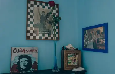a room with two pictures on the wall and a clock at Casa Particular 25Rooms in Rome
