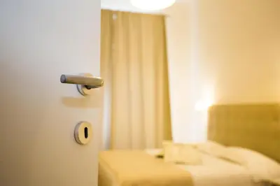 a room with two beds and a door with a mirror at I Mulini A Vento in Rome