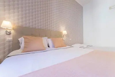 a bedroom with a large white bed with two pillows at I Mulini A Vento in Rome