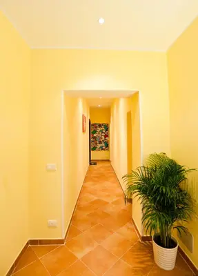 a hallway with two potted plants in a building at Rome Services Porta Castello in Rome
